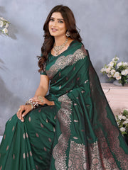 Woman wearing a floral dress with purple accents standing in front of a decorative white screen.