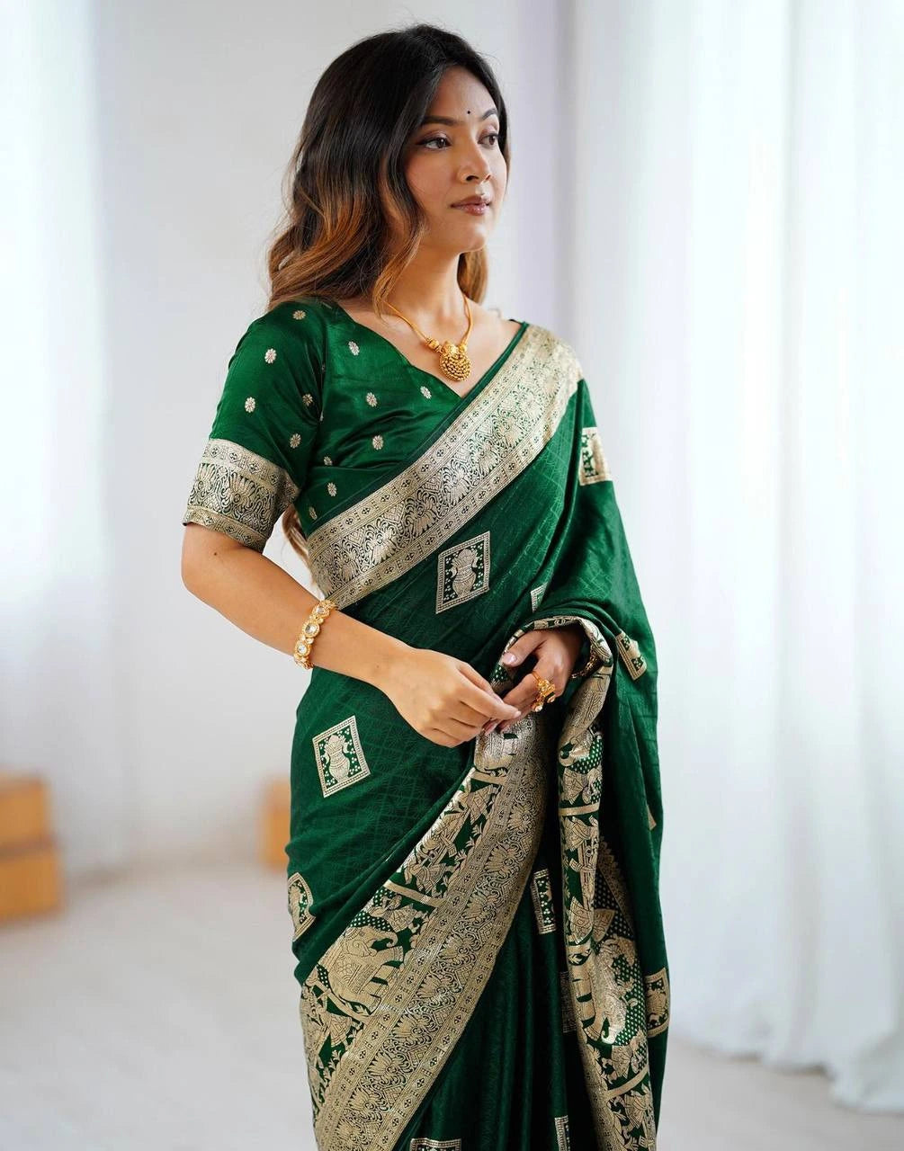 Woman wearing a green saree with a white background