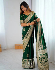 Woman holding a green saree with gold patterns in a minimalistic setting