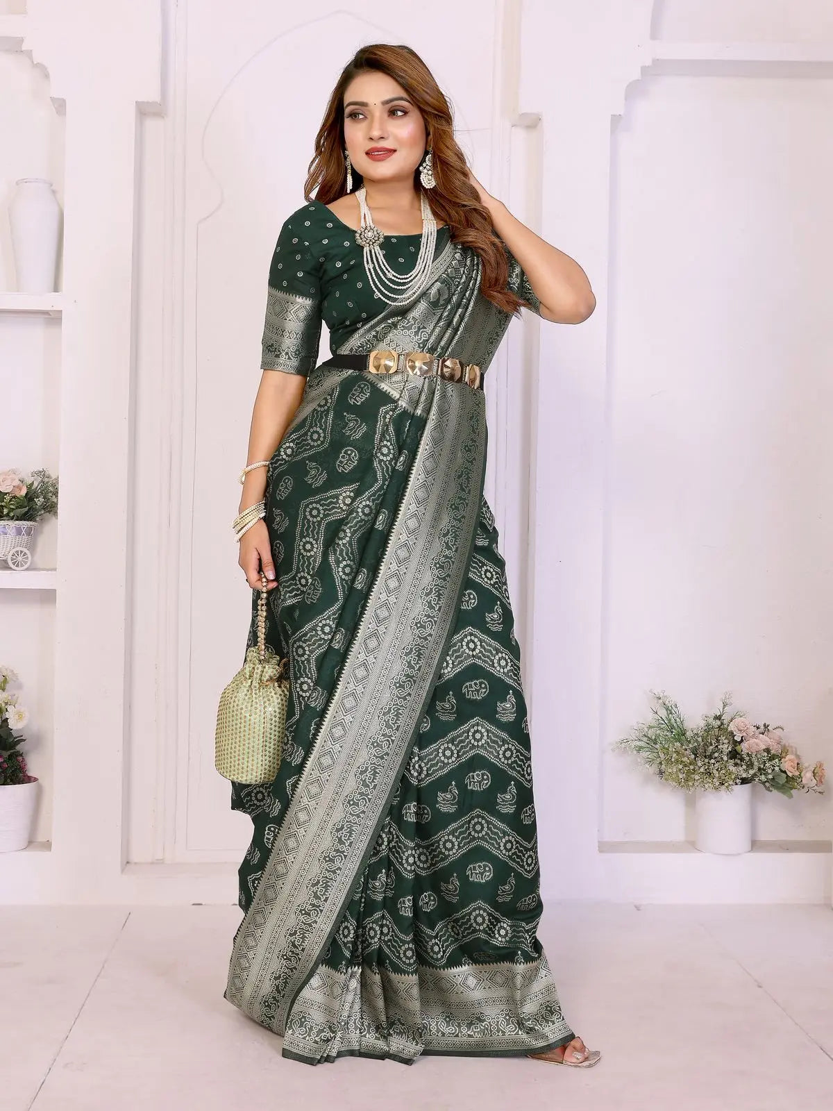Woman wearing a green and gray saree with a white background