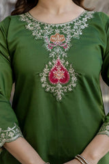 Green top with intricate embroidery on a plain background