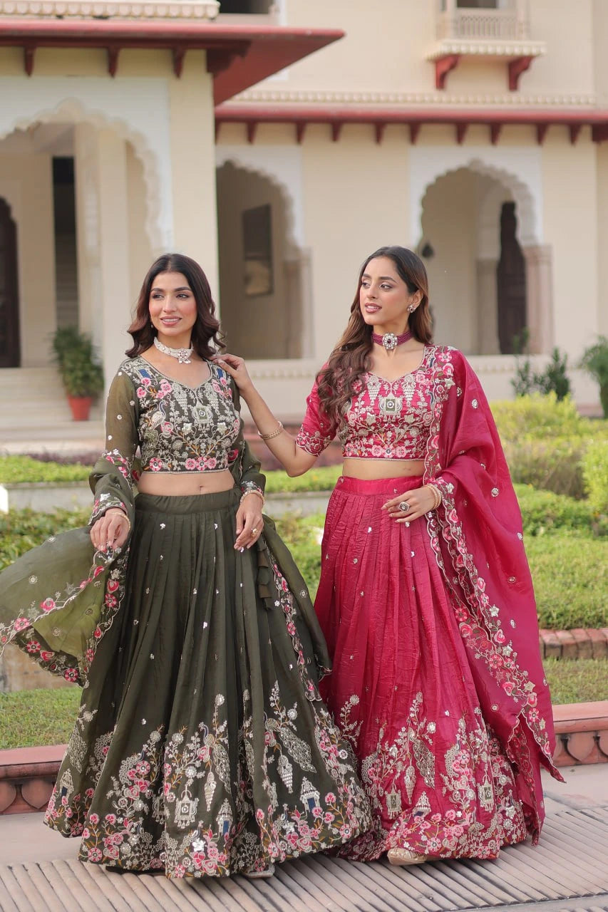Two women in traditional outfits standing outdoors with a building in the background