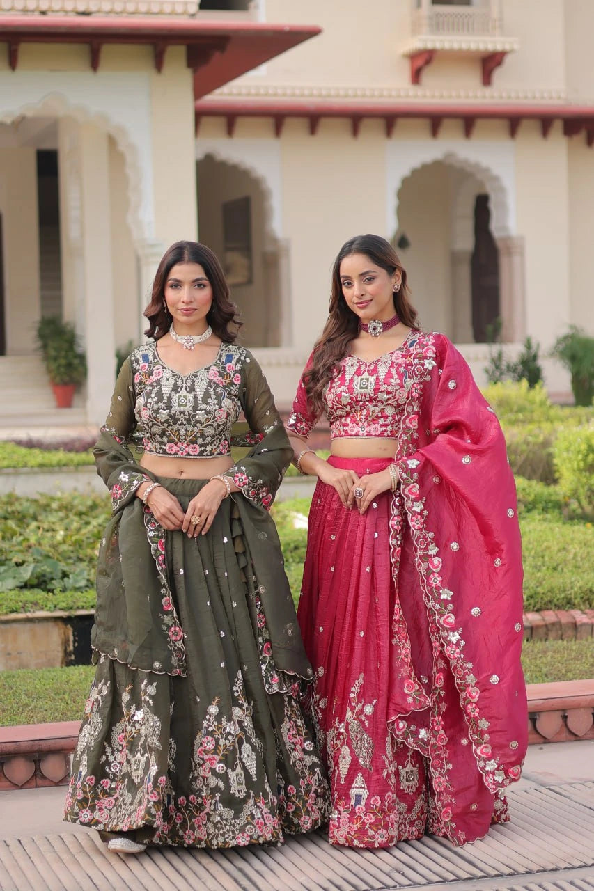 Two women in traditional outfits standing outdoors with a building in the background