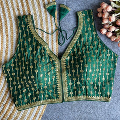 Green embroidered blouse on a striped fabric background