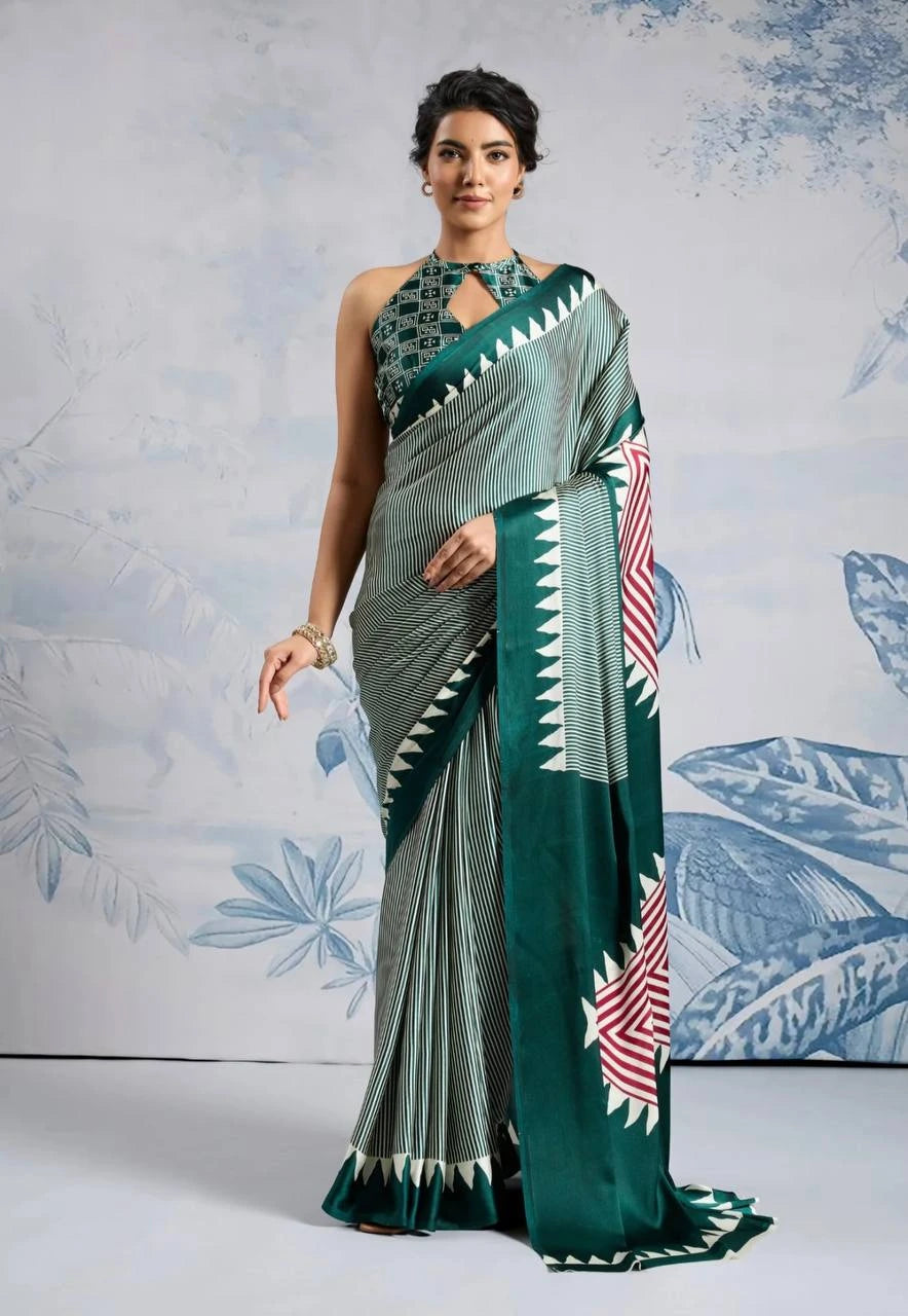 Woman wearing a green saree with white patterns against a light blue floral background