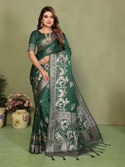 Woman wearing a green saree with floral patterns on a green background