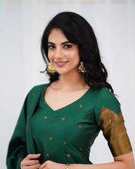 Woman wearing a green traditional outfit with gold embroidery on a white background