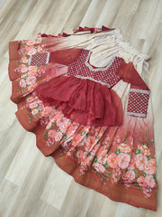 Red and pink floral dress with matching headscarf on a wooden floor