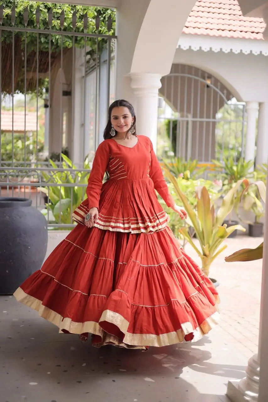 Premium Burnt Orange Party Wear Lehenga with Tiered Design, Golden Trim, and Graceful Traditional Look