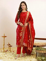 Woman wearing a red traditional outfit with gold details on a neutral background