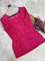 Pink patterned fabric on a hanger with a white background