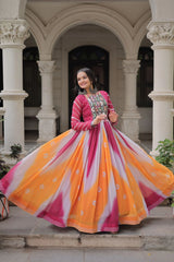 Woman in a colorful traditional outfit standing in an architectural setting