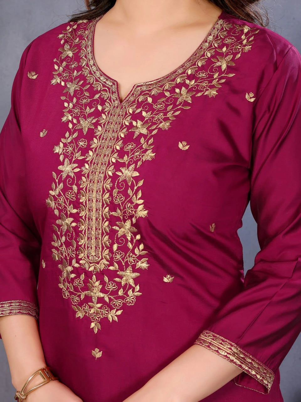 Maroon kurta with gold embroidery on a plain background