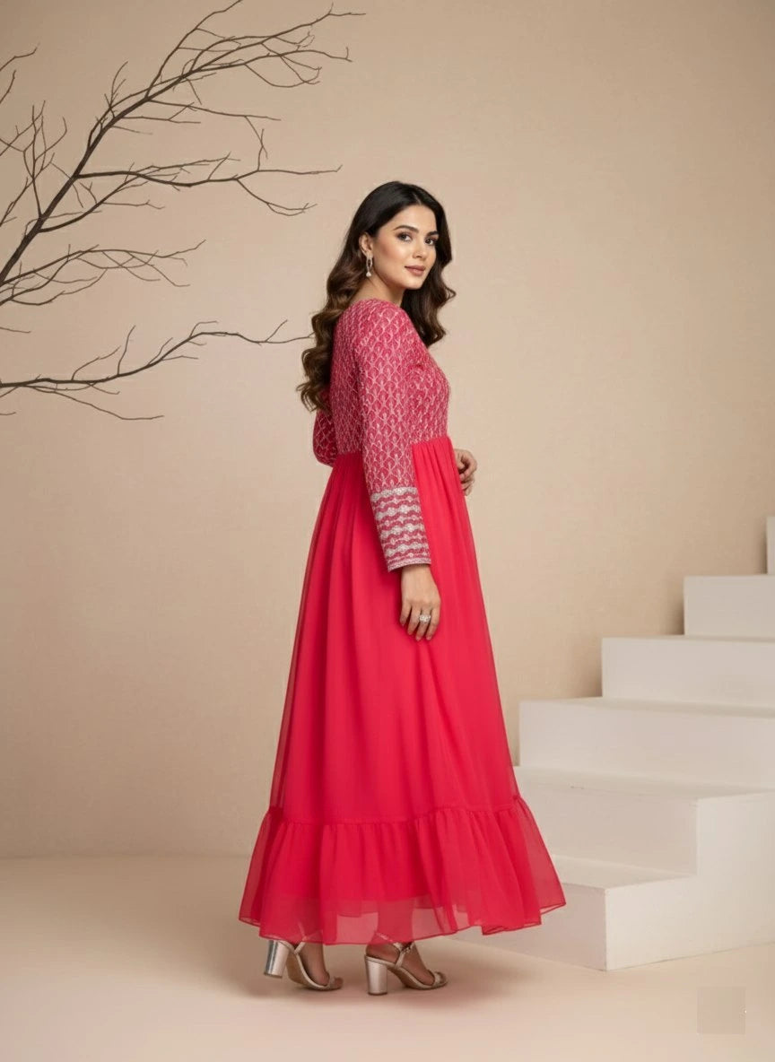 Woman in a red dress standing in front of a beige wall with white steps.