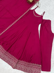 Maroon outfit with embroidered details on a white background