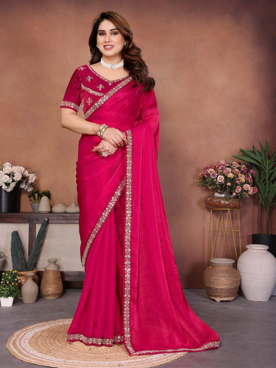 Woman wearing a pink saree with a brown background