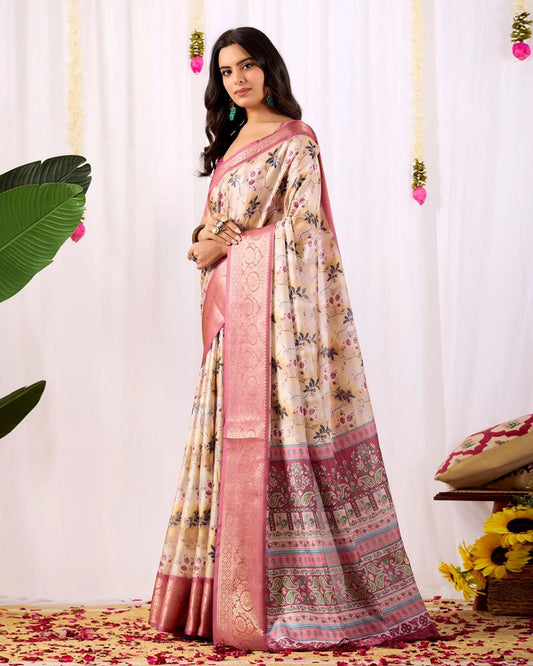 Woman wearing a floral saree with a pink border against a white curtain background