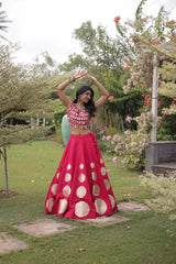 Stylish ethnic outfit combining a contemporary mirror work blouse with a graceful full-flare designer skirt.