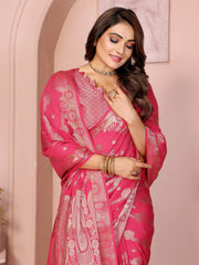 Woman wearing a pink saree with white patterns against a light pink background
