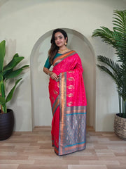 Woman in a pink saree standing in a room with plants