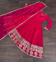 Red saree with gold embroidery on a wooden floor