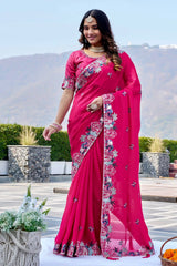 Woman wearing a pink saree with floral patterns outdoors