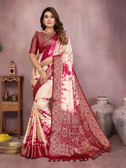 Woman wearing a red and white saree with intricate patterns in a decorative setting.