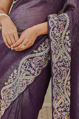 Close-up of a purple saree with intricate white embroidery