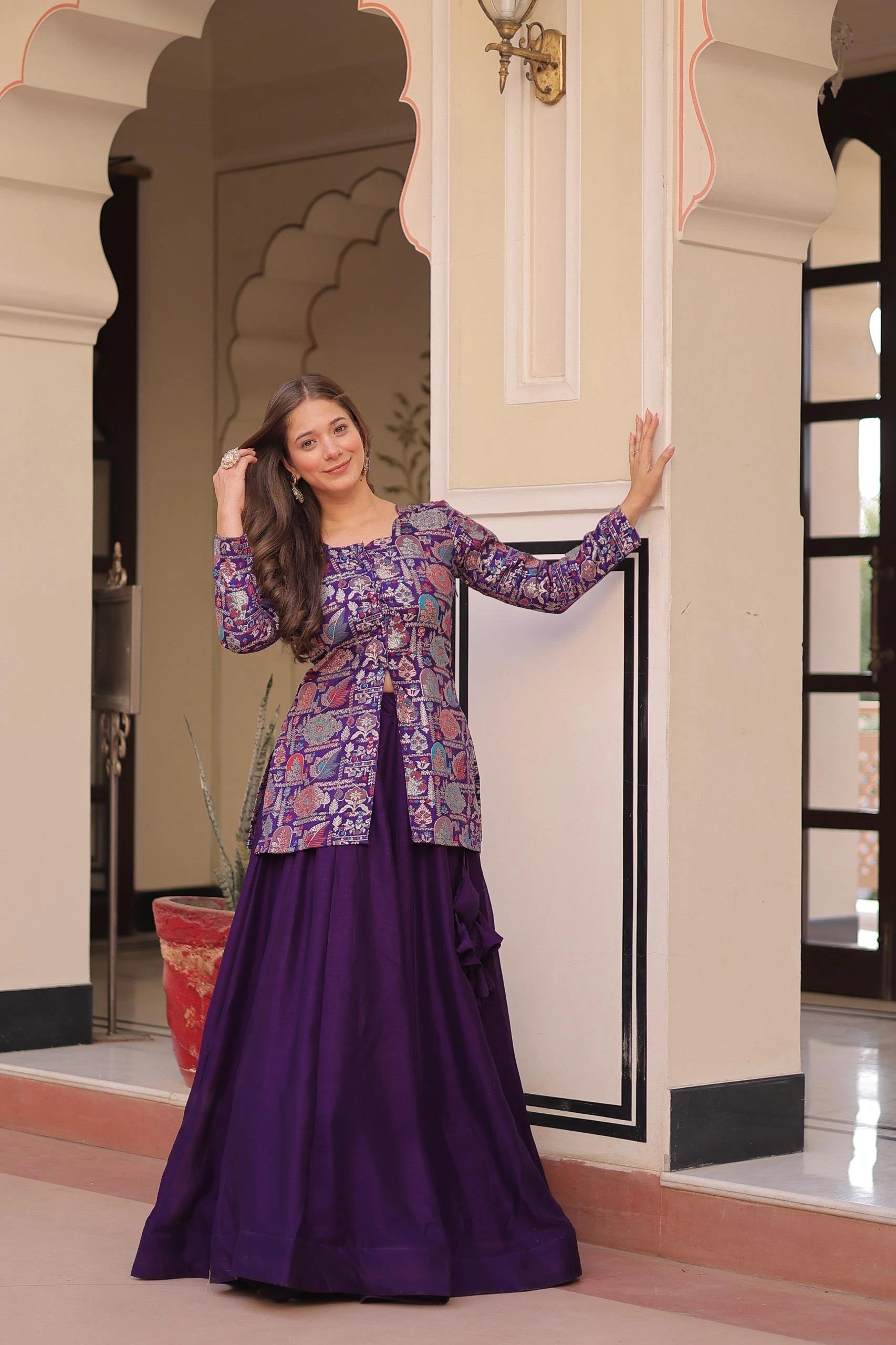 Woman in a traditional outfit standing in an ornate indoor setting