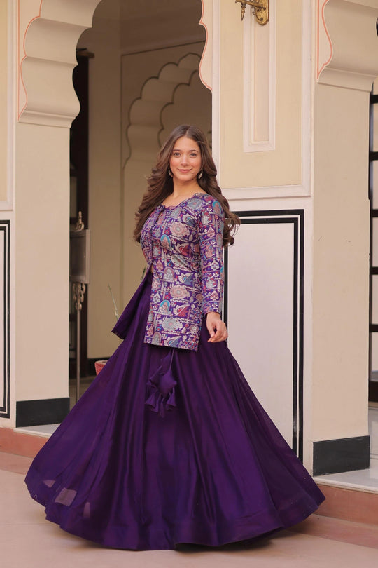 Woman in a purple traditional outfit standing in an ornate doorway.