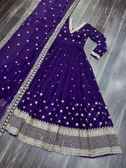 Purple traditional outfit with white floral patterns on a wooden floor