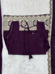 A woman models a rich plum ethnic outfit featuring elegant silver embroidered details.
