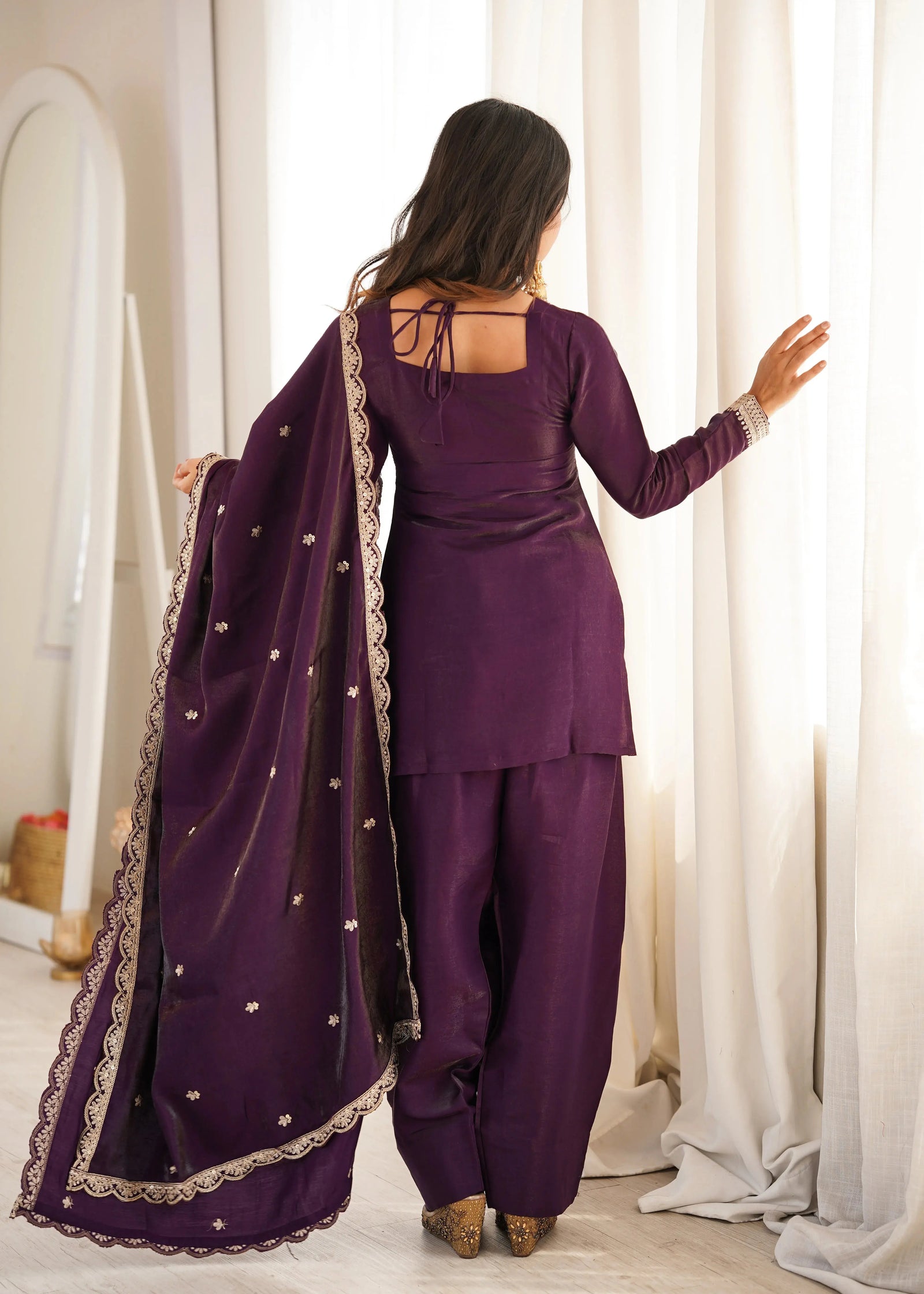 The embroidered neckline, cuffs, and hem add a refined and luxurious touch.