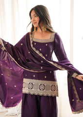 Woman wearing a purple traditional outfit with gold embroidery in a bright setting