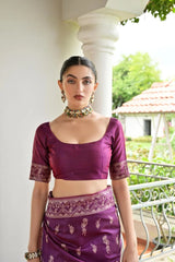 Woman wearing a purple traditional outfit with a white background