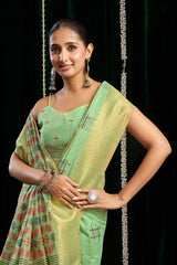 Woman wearing a green saree with a black background