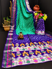 Colorful saree with a patterned tablecloth and decorative items on a black background