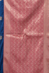 Close-up of a pink fabric with intricate patterns on a blue background