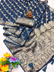 Blue and beige patterned saree with a small statue and flowers on a white background