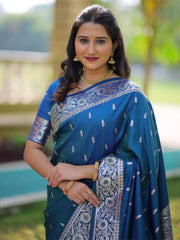 Woman wearing a blue saree with white patterns outdoors