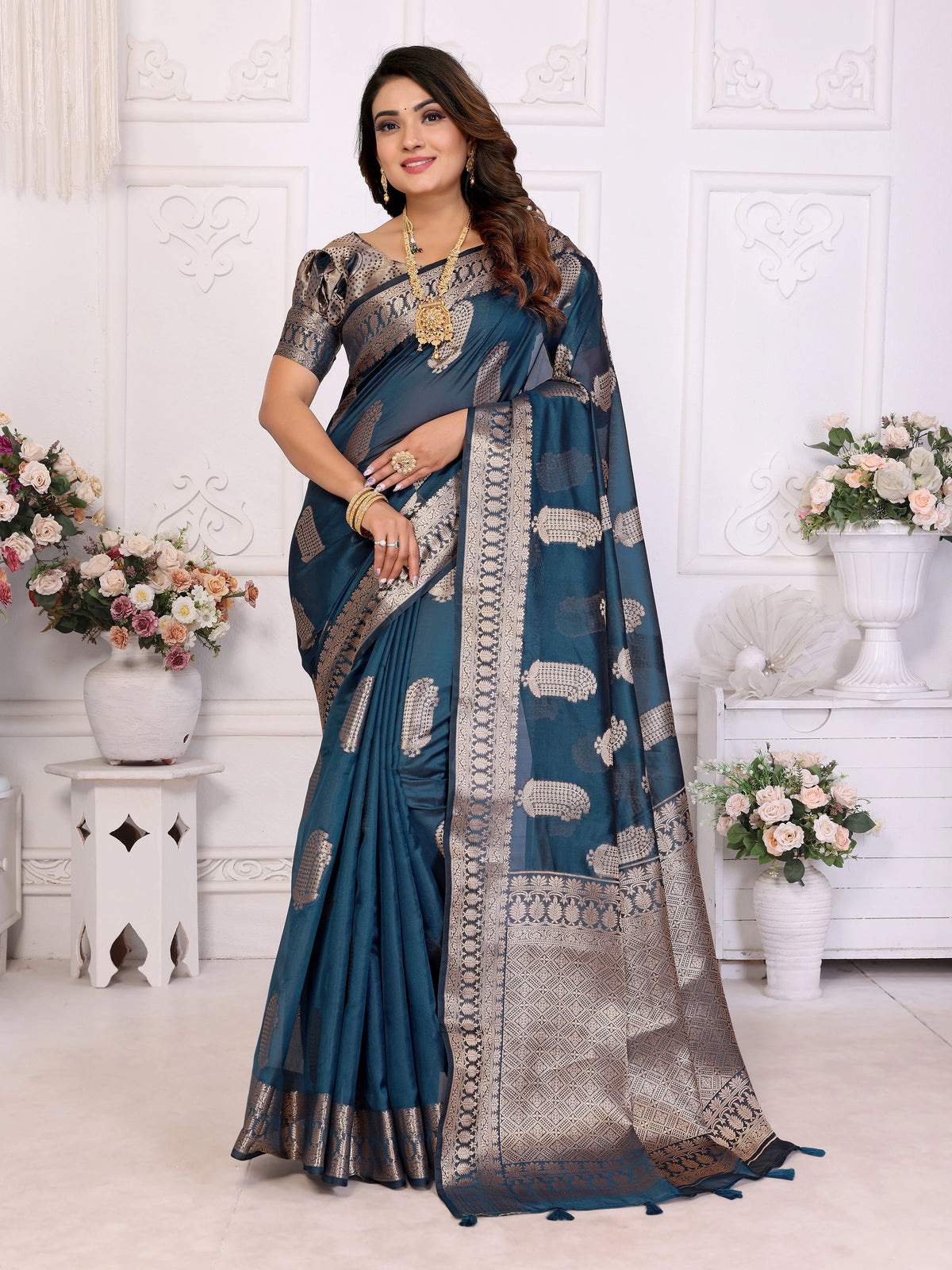 Woman wearing a blue saree with a white background