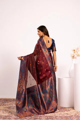 Woman wearing a traditional saree with a floral pattern on a white background