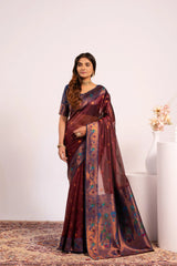 Woman wearing a maroon saree with a floral pattern on a white background