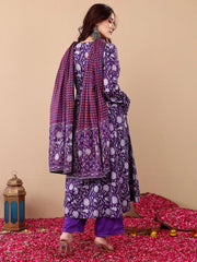 Woman wearing a purple and white patterned traditional outfit on a beige background with decorative elements.