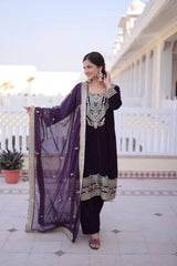 Woman in a traditional outfit standing on a tiled floor with a white building in the background