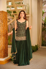 Woman in a green traditional outfit standing indoors with decorative elements.