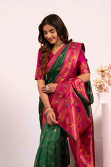 Woman wearing a pink and green saree with a white background