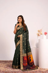 Woman wearing a green saree with a colorful border against a white background