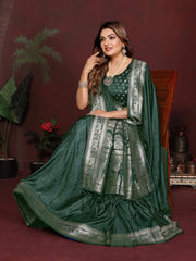 Woman in a green traditional outfit with silver details against a maroon background