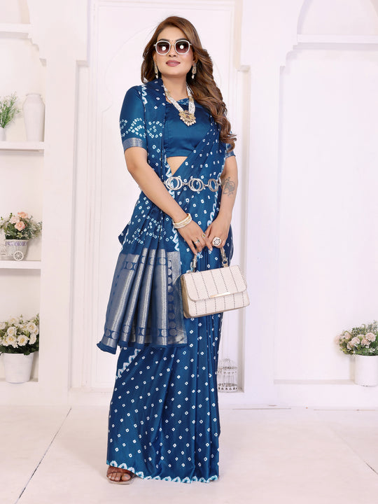 Woman wearing a blue patterned outfit with a white handbag in a minimalistic setting.
